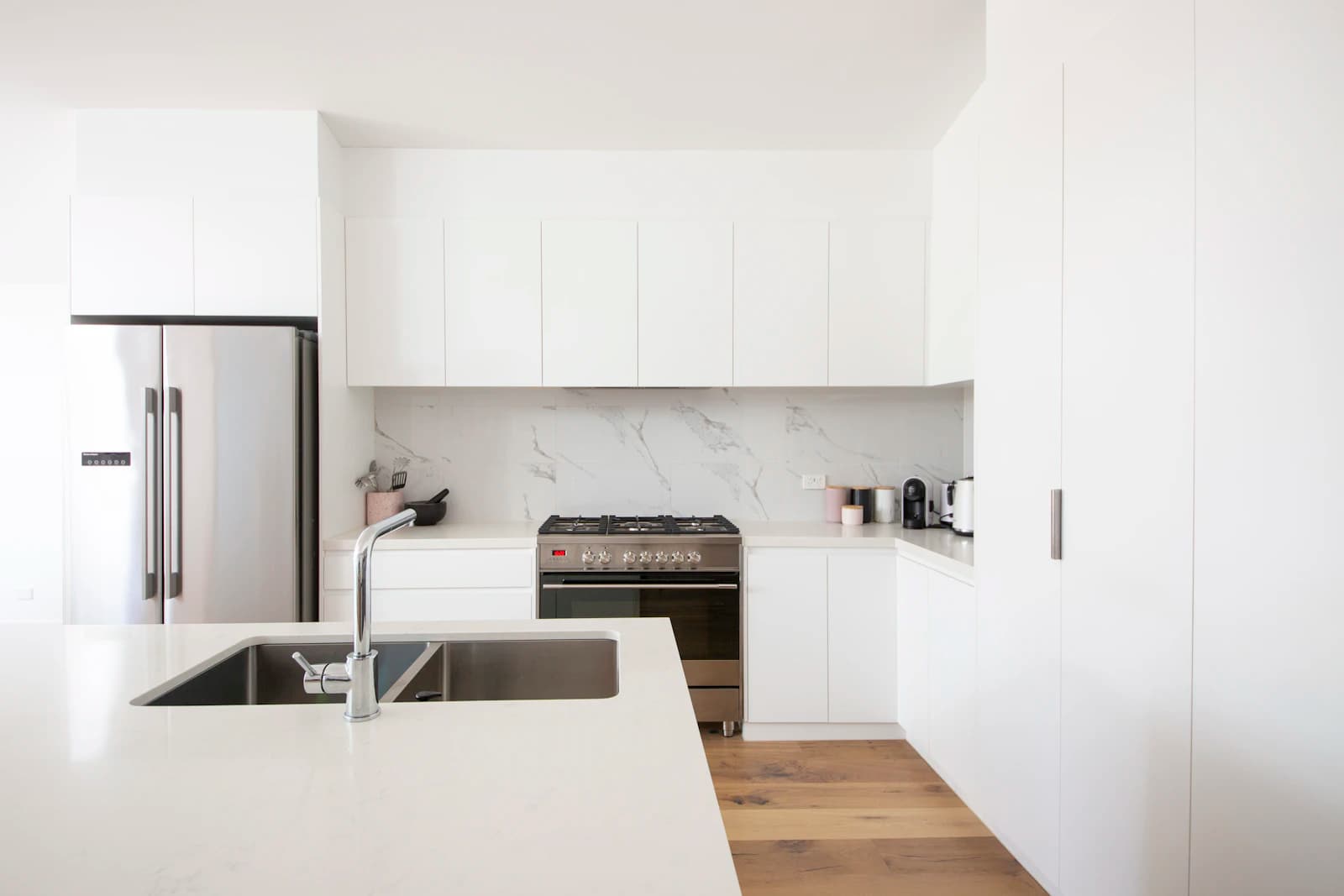 Modern clean kitchen with built-in oven and clear surfaces